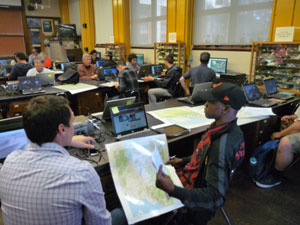 Students working with maps and computers in S45 lab.